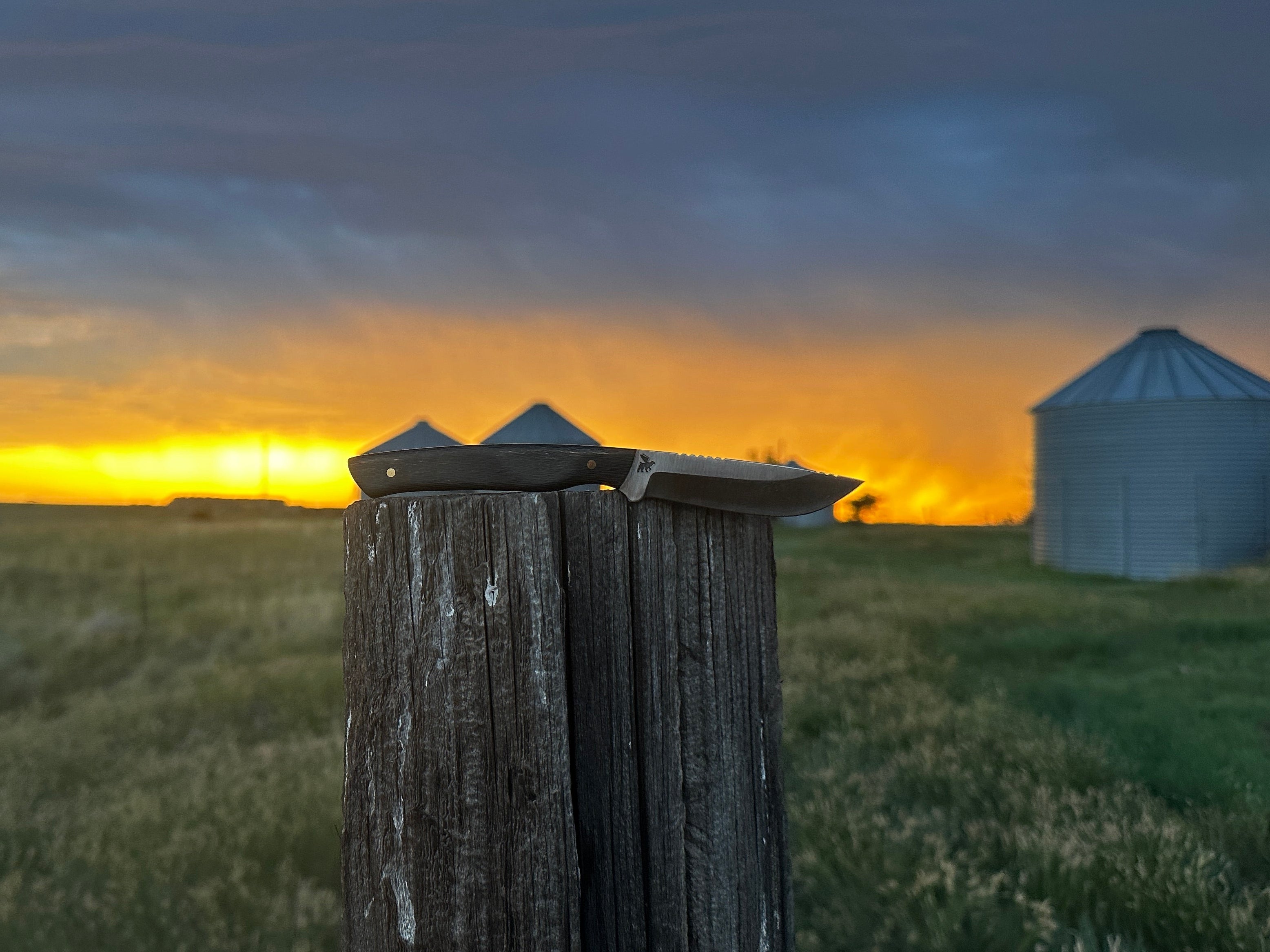 One of the best hunting knives on a fence post at sunset. 